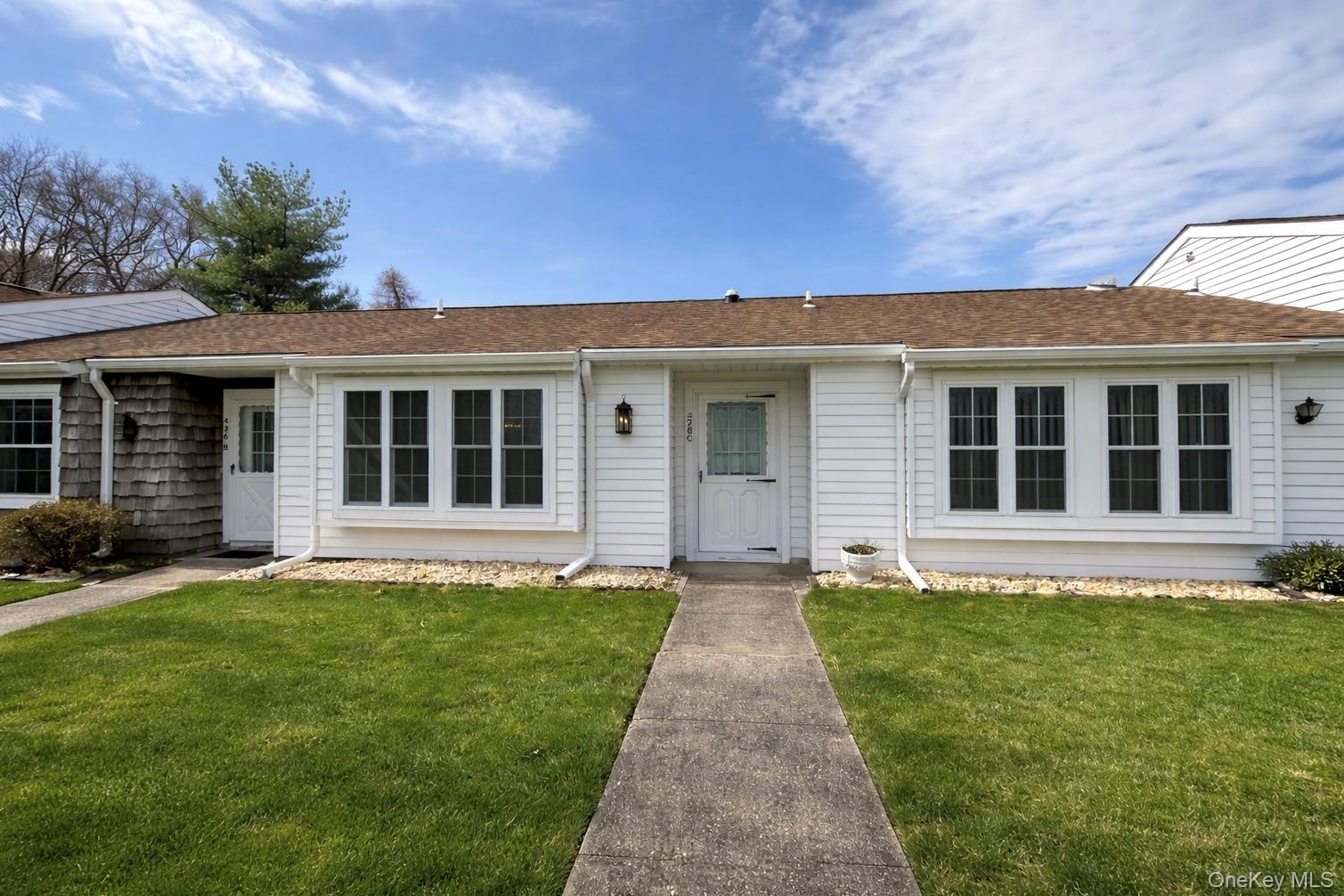 426 Aylesbury Court, Unit C Ridge, NY 11961 - Photo 1 of 1 front view of a house with a yard