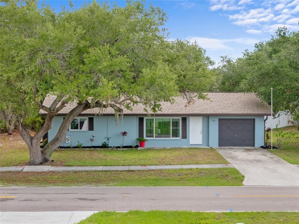 1510 Orlando Boulevard Port Charlotte, FL 33952 - Photo 1 of 1 a front view of a house with garden