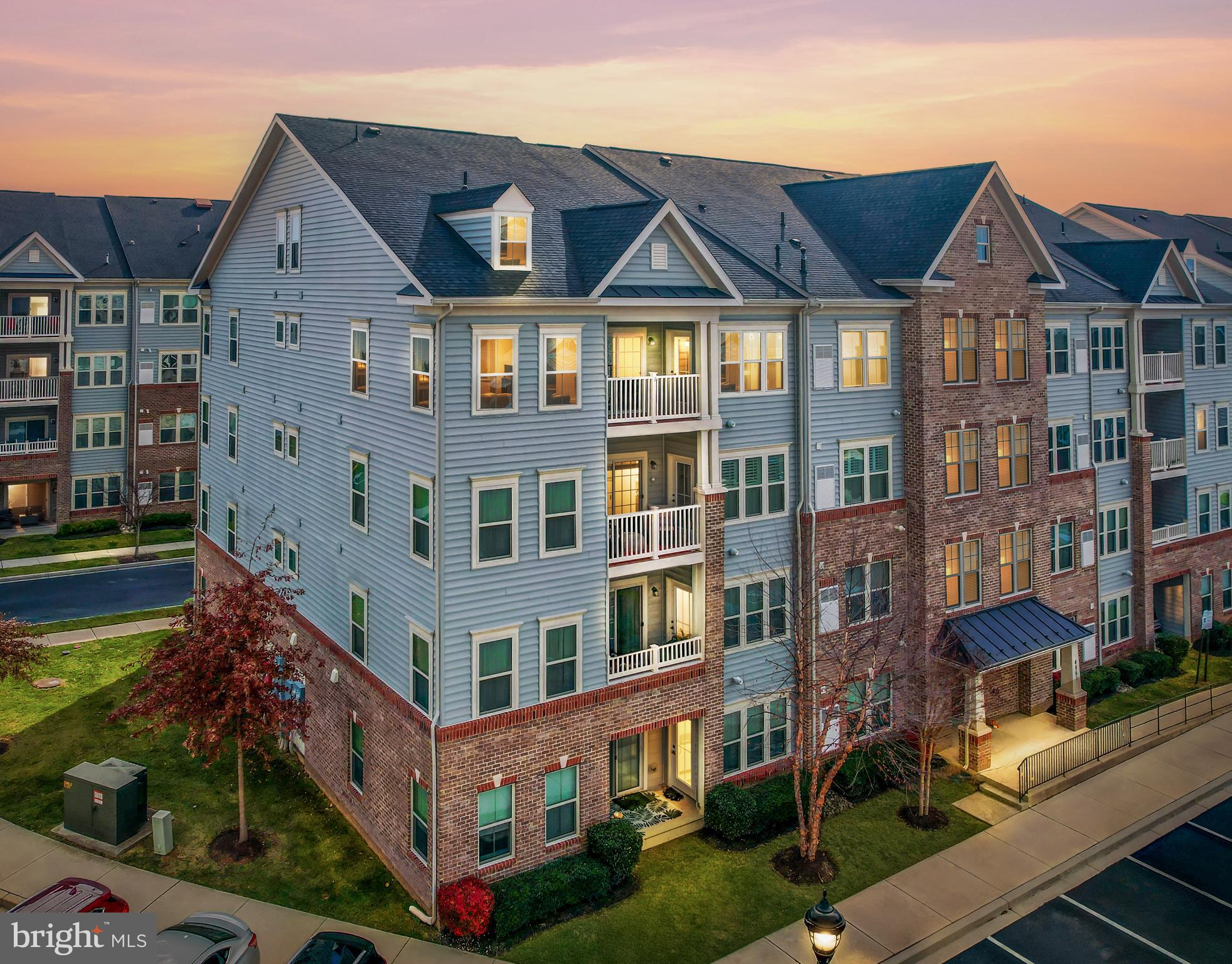 a front view of a residential apartment building with a yard