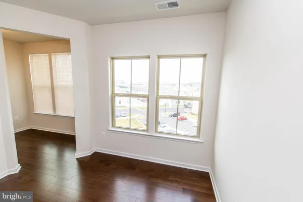 a view of a hallway and wooden floor