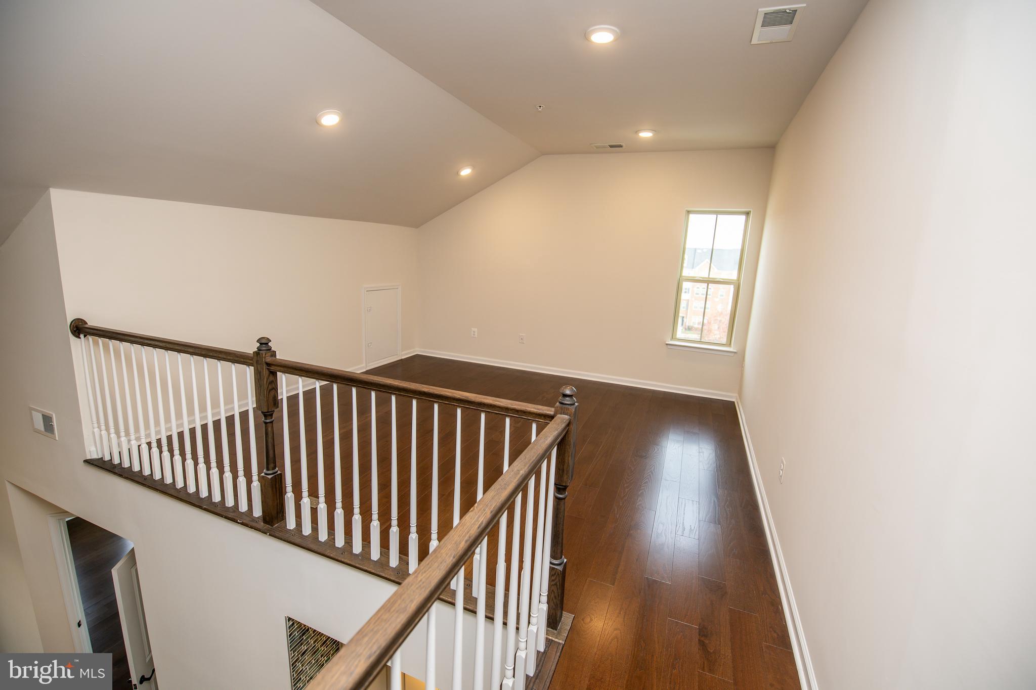 4861 Finnical Way, Unit 401 Frederick, MD 21703 - Photo 19 of 54 a view of a hallway and wooden floor
