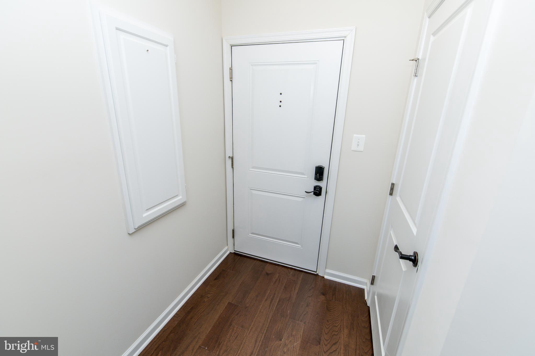 4861 Finnical Way, Unit 401 Frederick, MD 21703 - Photo 21 of 54 a view of a hallway with wooden floor and closet
