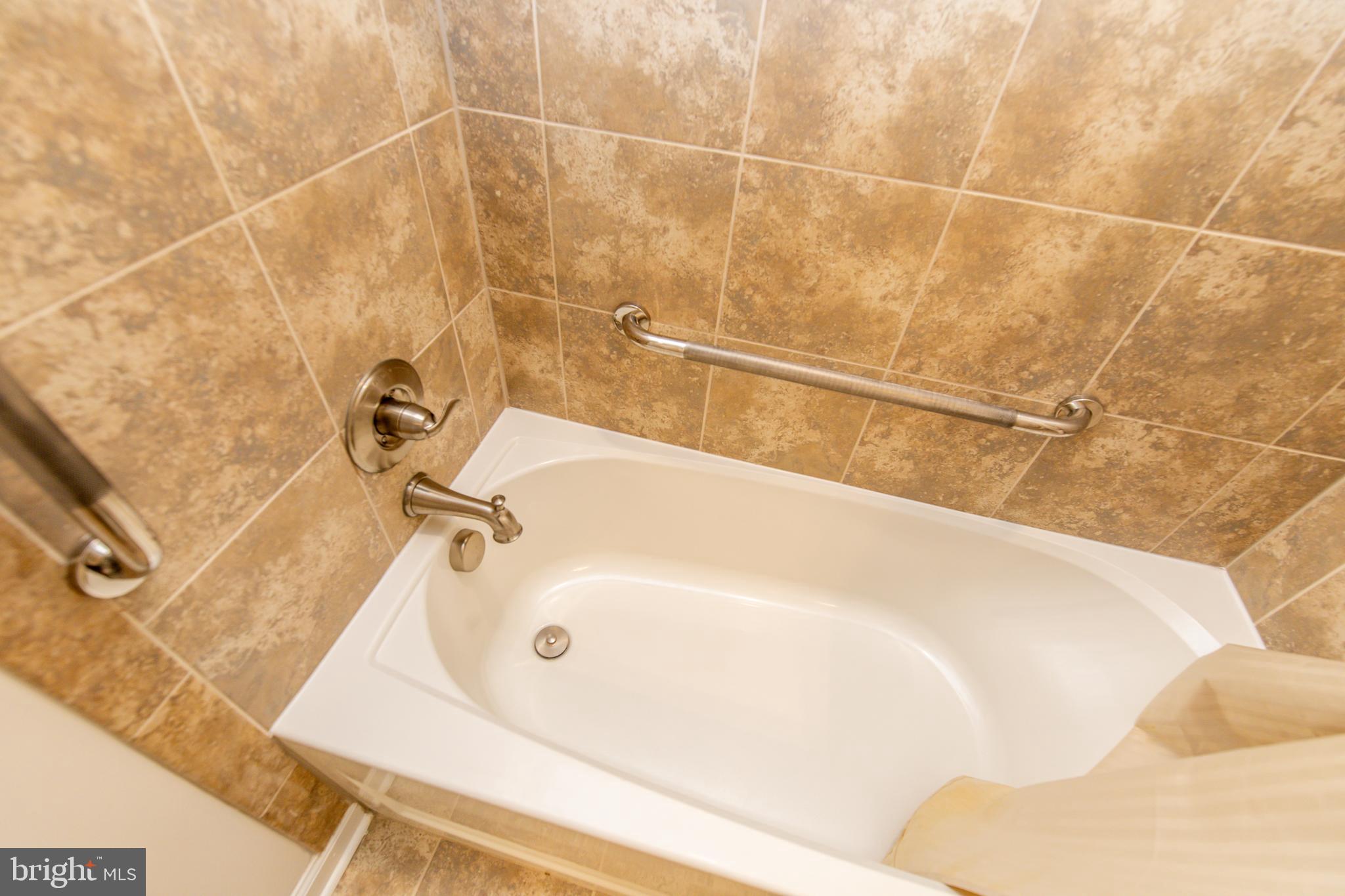 4861 Finnical Way, Unit 401 Frederick, MD 21703 - Photo 26 of 53 a bathroom with a bathtub