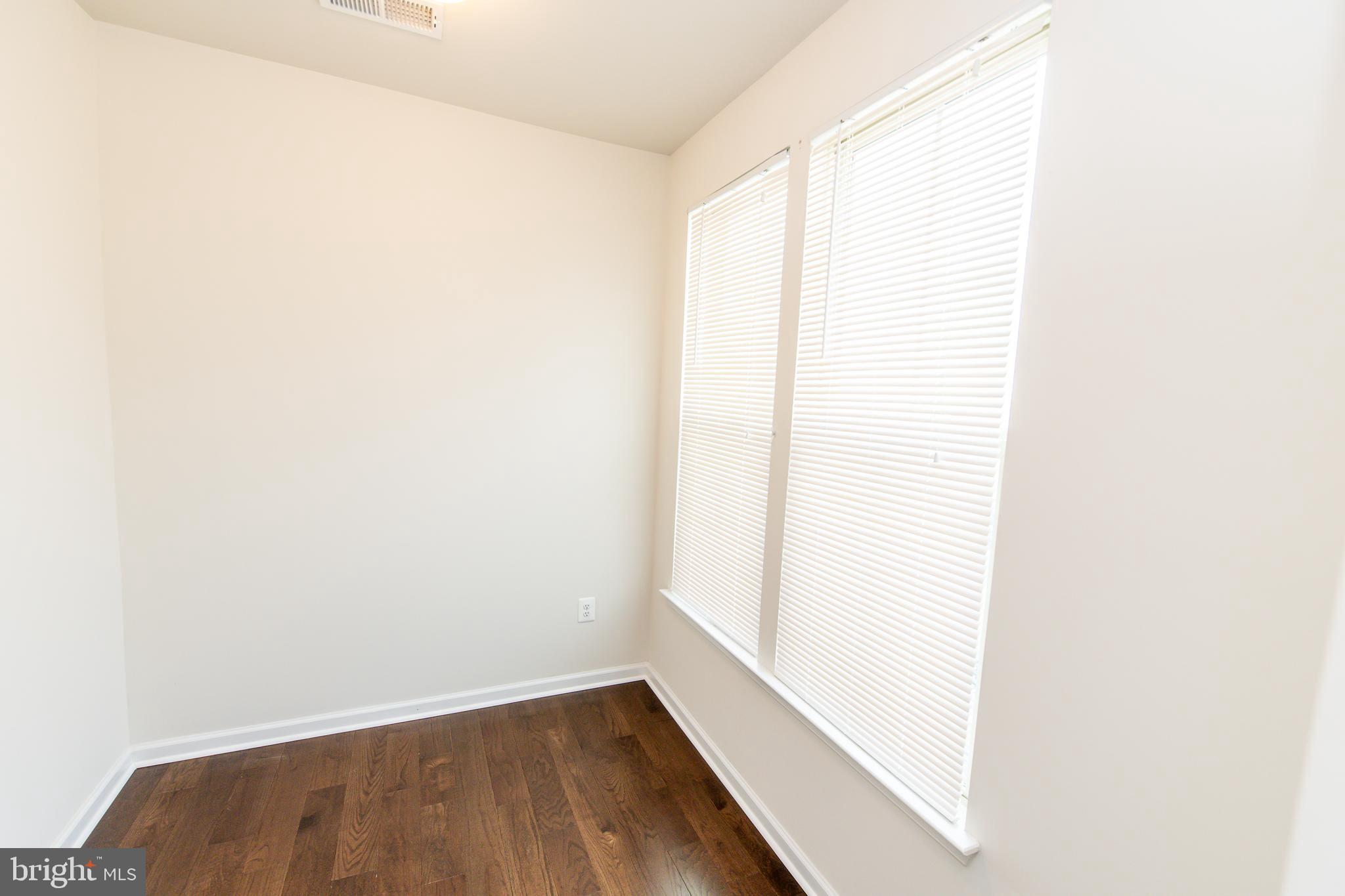 4861 Finnical Way, Unit 401 Frederick, MD 21703 - Photo 30 of 54 a view of a room with wooden floor