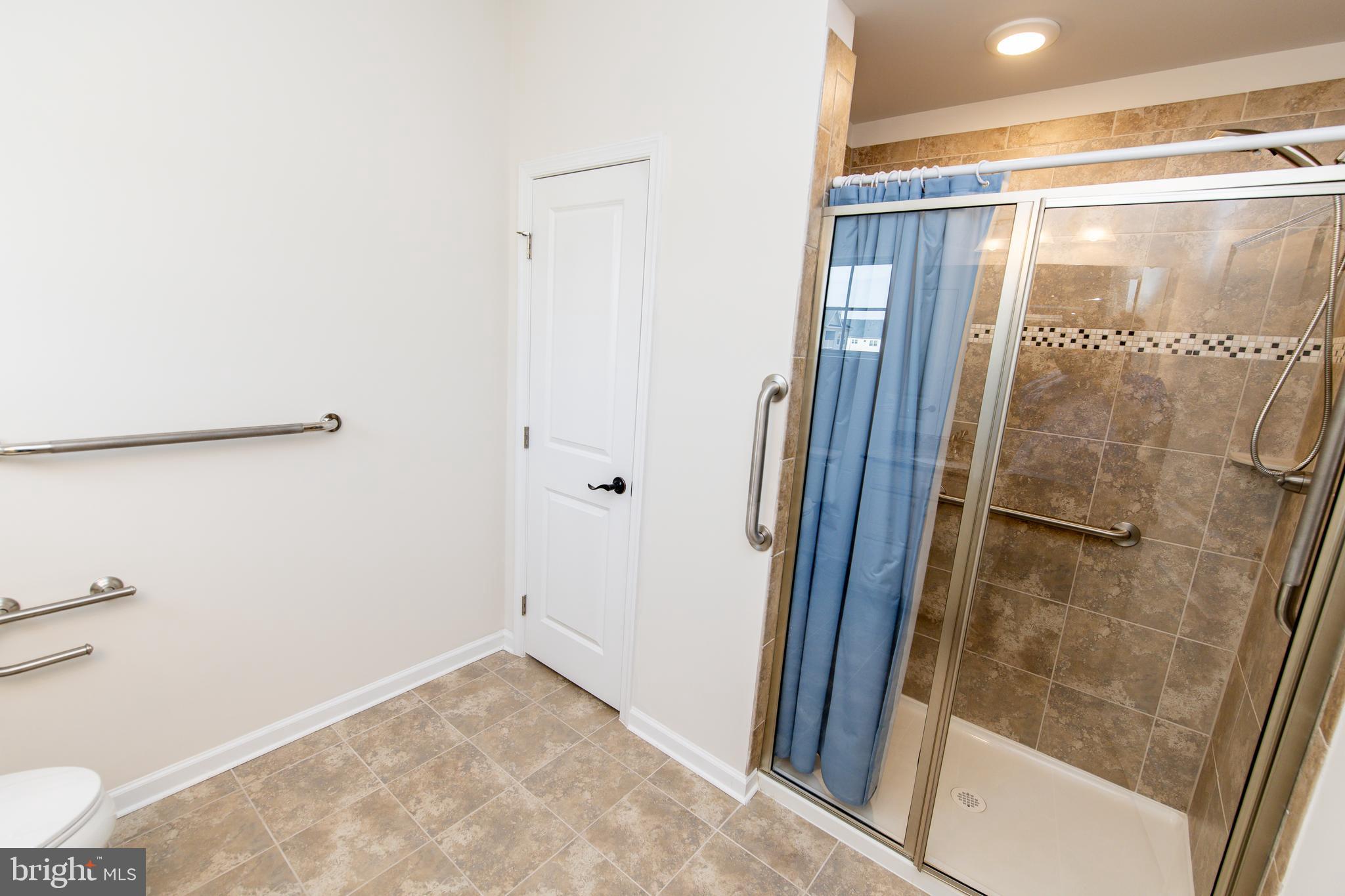 4861 Finnical Way, Unit 401 Frederick, MD 21703 - Photo 33 of 53 a bathroom with a glass shower door
