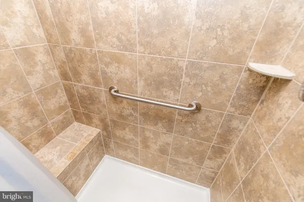a spacious bathroom with a granite countertop sink a toilet and a mirror
