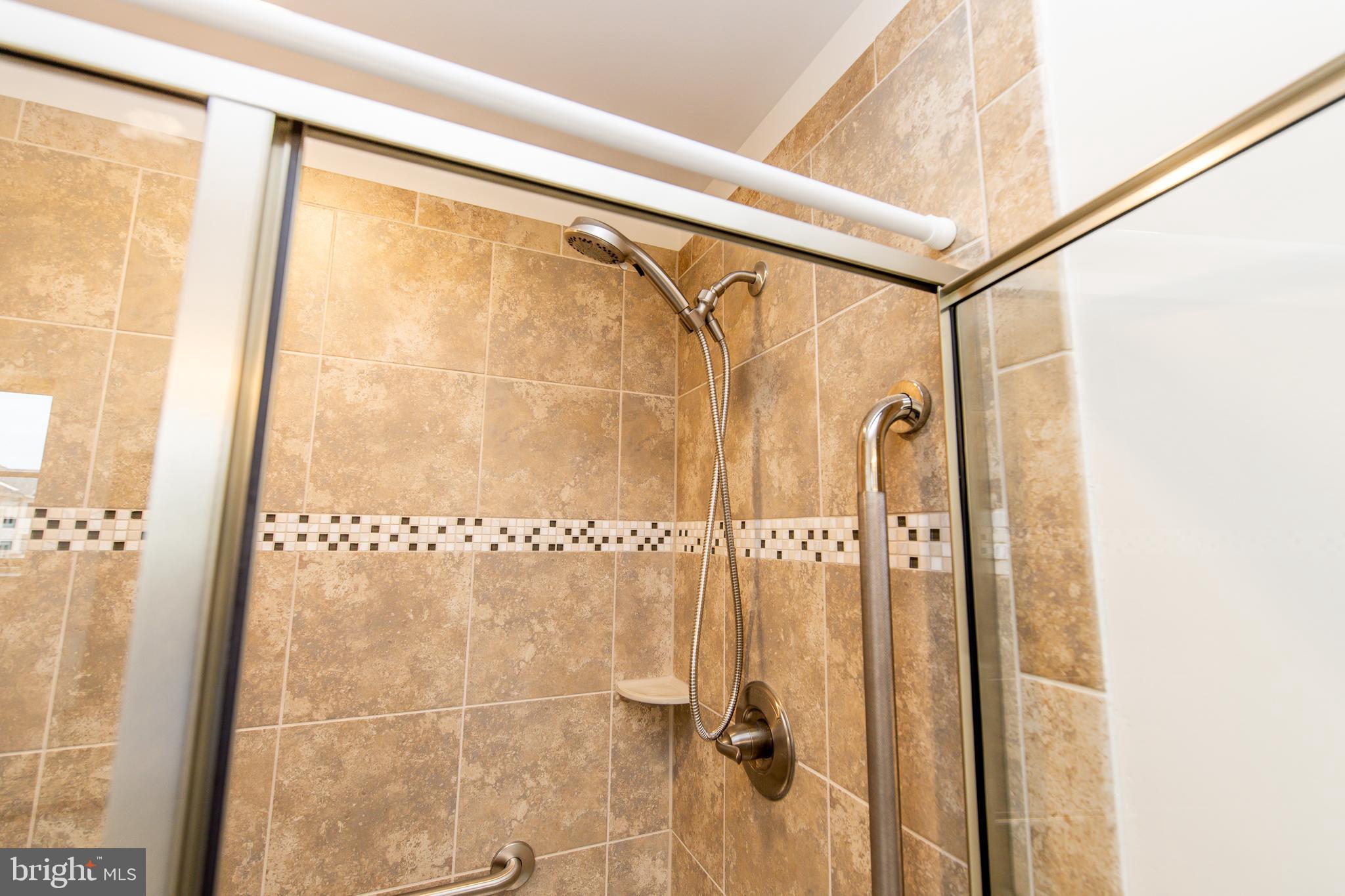 4861 Finnical Way, Unit 401 Frederick, MD 21703 - Photo 35 of 53 a bathroom with a shower and a glass door