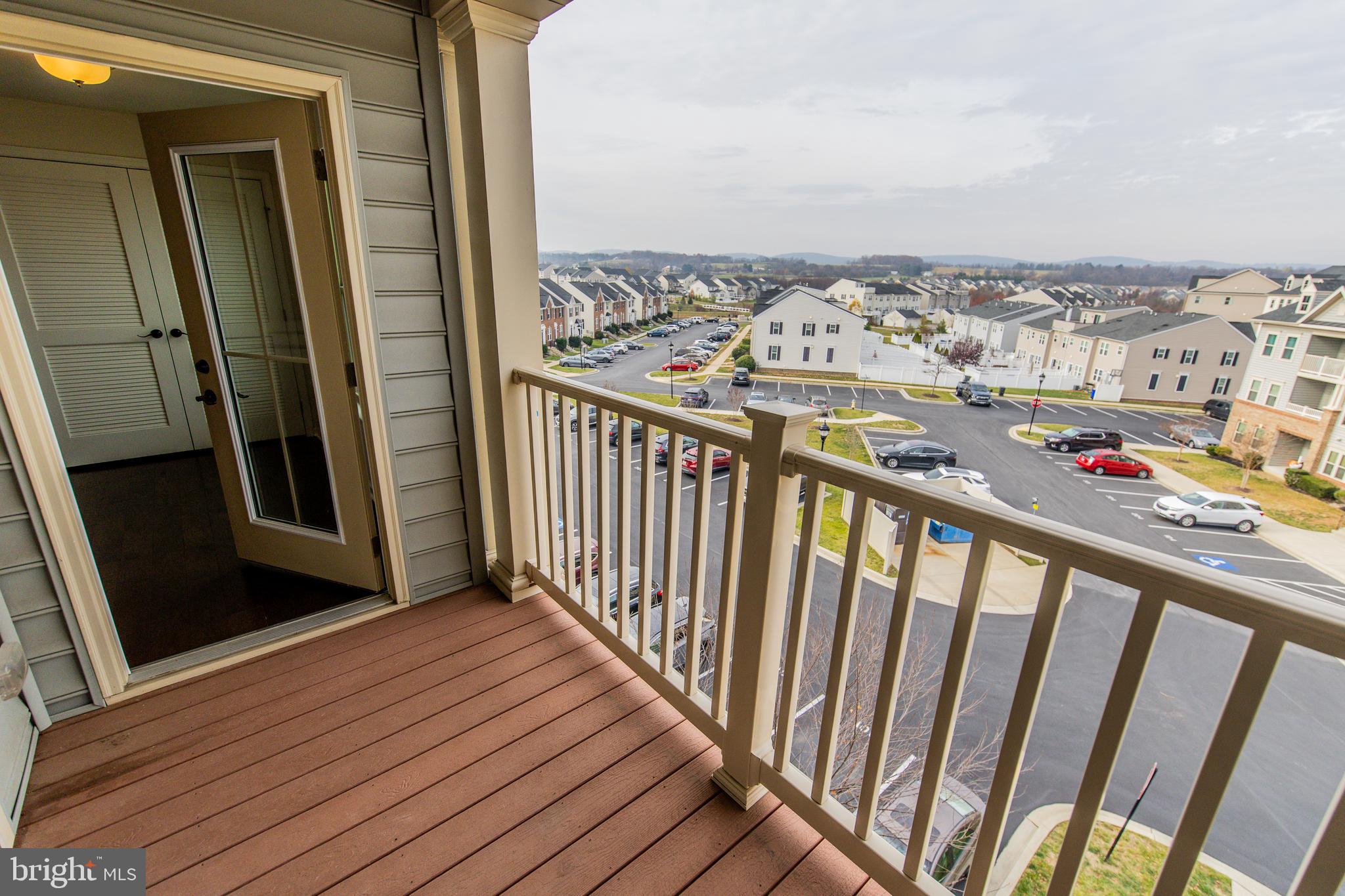 4861 Finnical Way, Unit 401 Frederick, MD 21703 - Photo 40 of 53 a view of a balcony with wooden floor