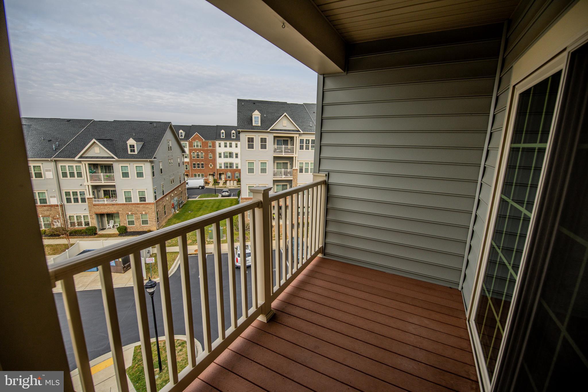 4861 Finnical Way, Unit 401 Frederick, MD 21703 - Photo 42 of 54 a view of a balcony with wooden floor