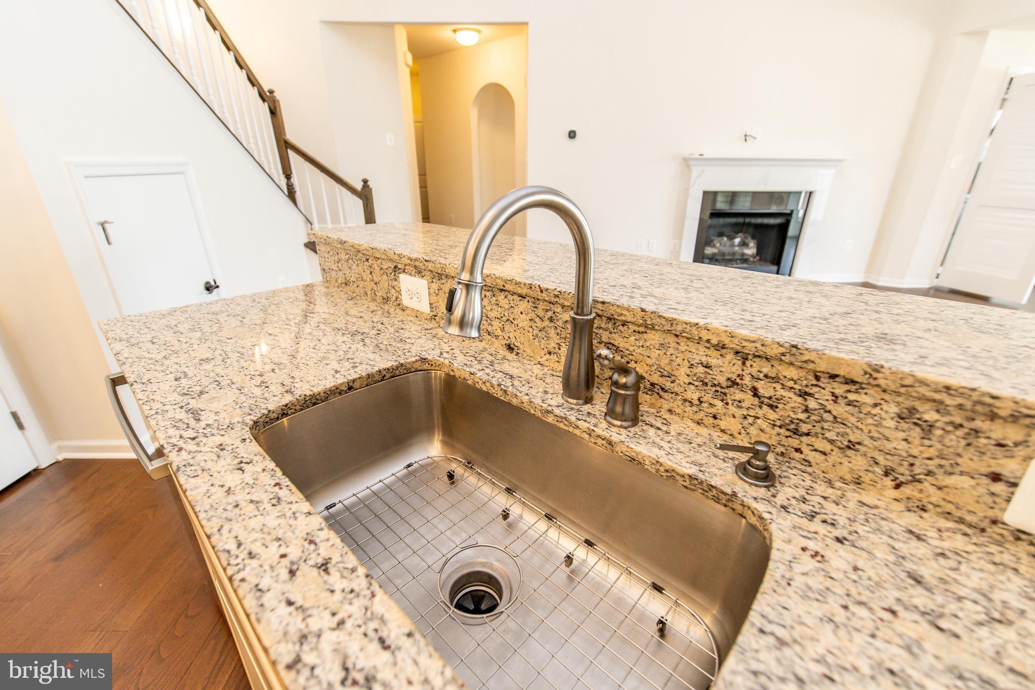 4861 Finnical Way, Unit 401 Frederick, MD 21703 - Photo 7 of 53 a close view of a sink a faucet and appliance in the kitchen
