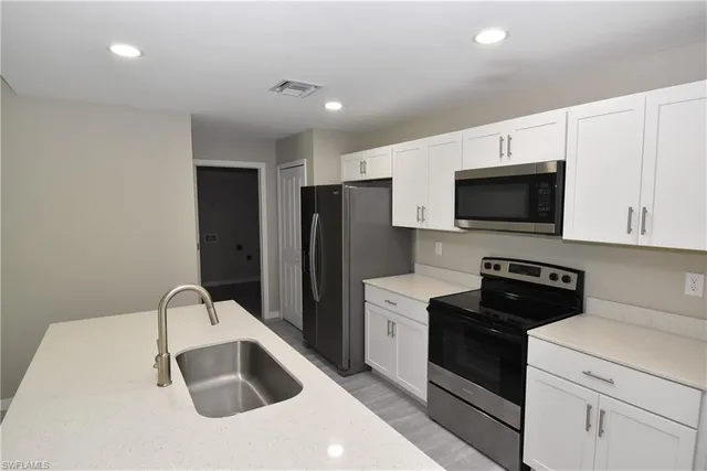 a view of kitchen with refrigerator and window