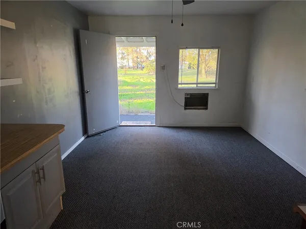 an empty room with a fireplace and a window
