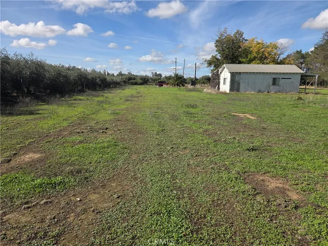 a view of a water pond with green yard