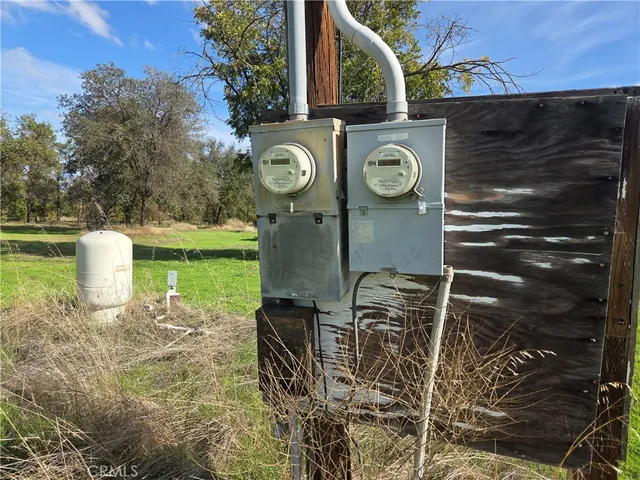 a view of yard with green space and trees in the background
