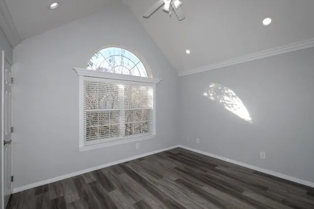 a view of an empty room with wooden floor and closet