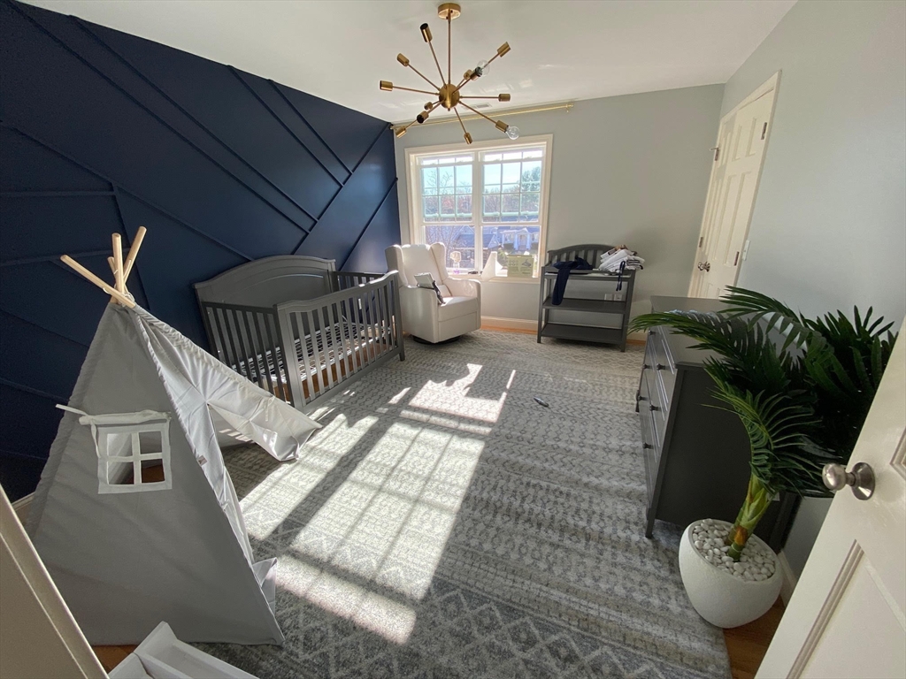 15 Spencer Street Methuen, MA 01844 - Photo 16 of 25 a living room with furniture and a chandelier
