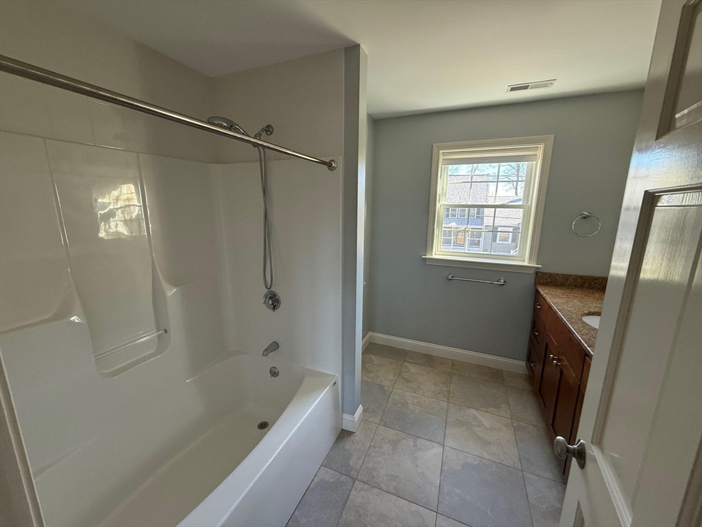 15 Spencer Street Methuen, MA 01844 - Photo 17 of 25 a bathroom with a tub shower vanity and a sink