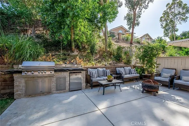 a view of a patio with table and chairs and potted plants