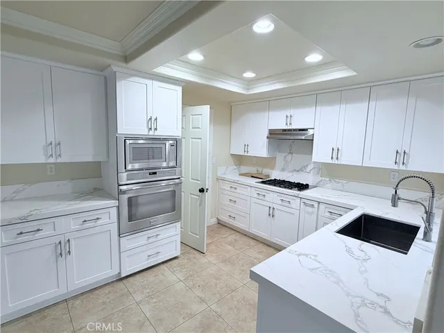 a kitchen with cabinets appliances and a sink
