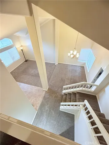 a view of a living room with furniture and a chandelier