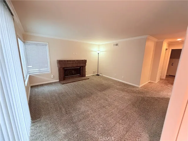 a view of empty room with a fireplace