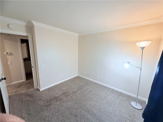 a view of a room with wooden floor and mirror