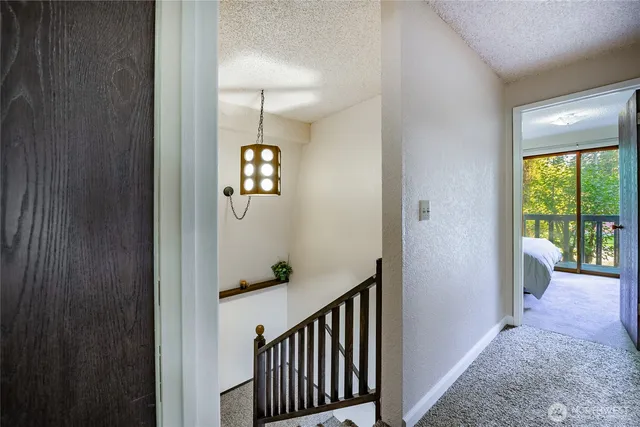 a view of a hallway to a livingroom with furniture