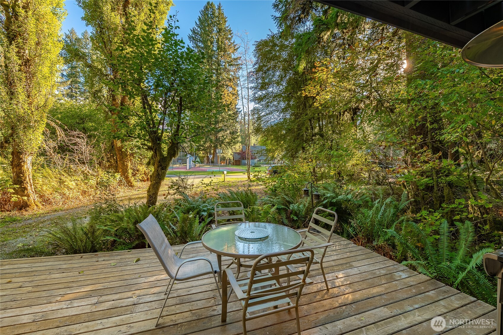7018 Olympus Way Glacier, WA 98244 - Photo 4 of 35 a balcony with wooden floor table and chairs