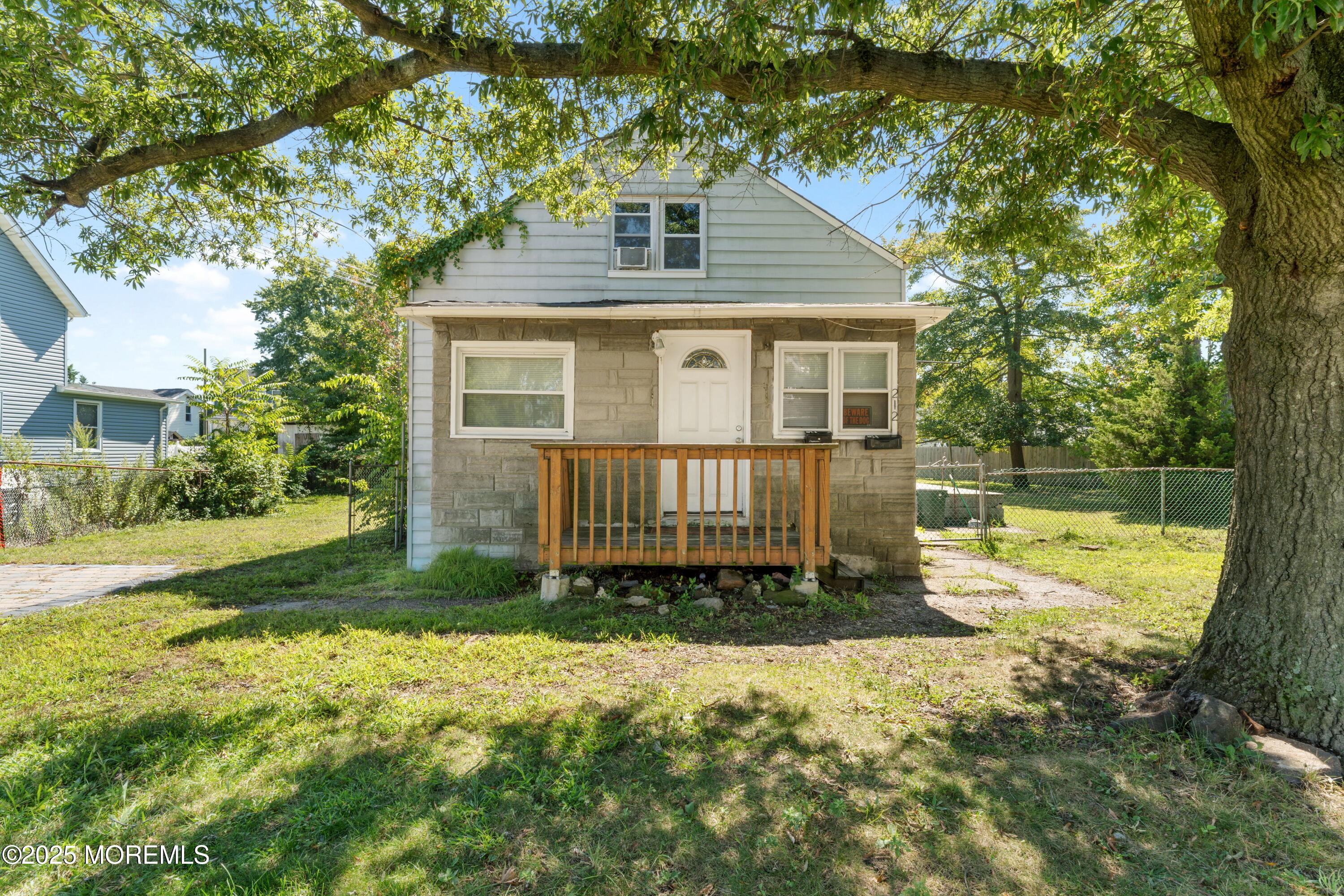 a view of a house with a yard and fence