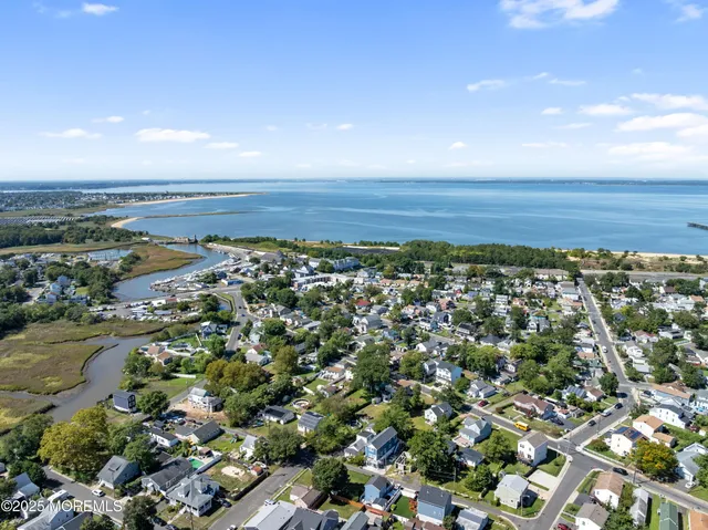 an aerial view of residential building and ocean