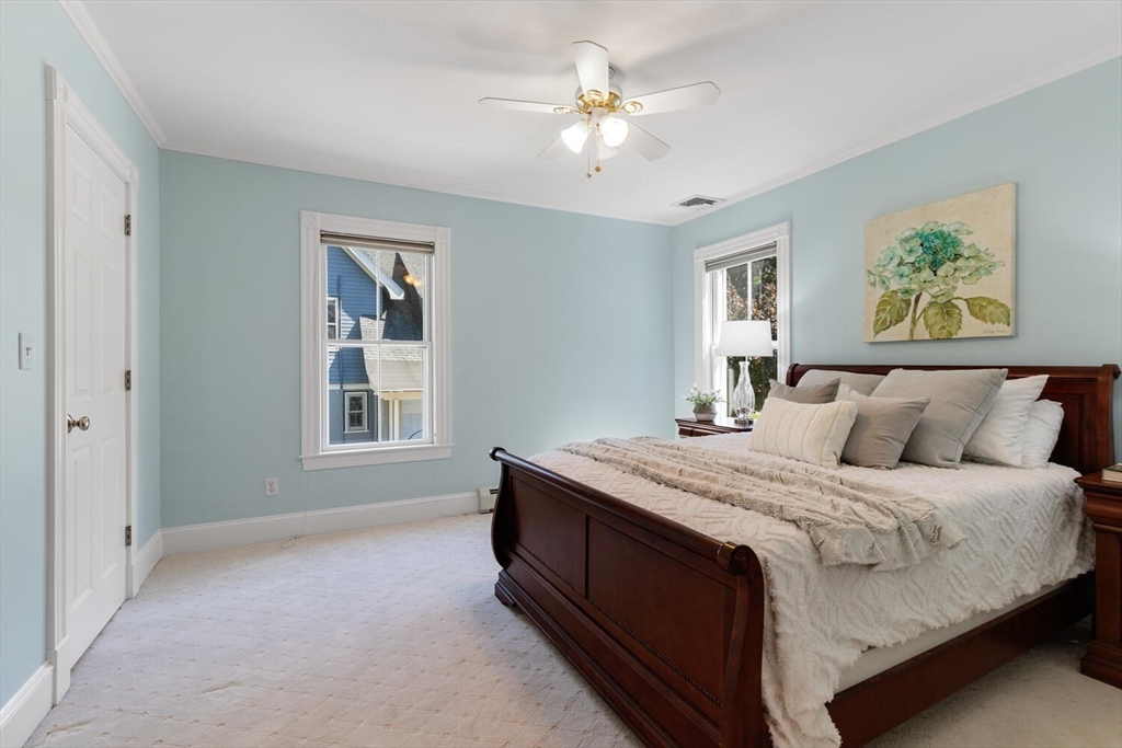 9 Bacon Street, Unit 9 Winchester, MA 01890 - Photo 15 of 35 a spacious bedroom with a bed and a chandelier