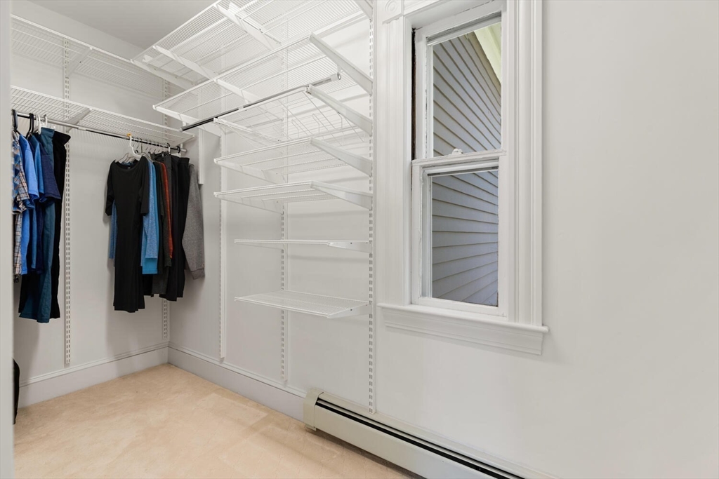 9 Bacon Street, Unit 9 Winchester, MA 01890 - Photo 16 of 35 a view of walk in closet with clothes