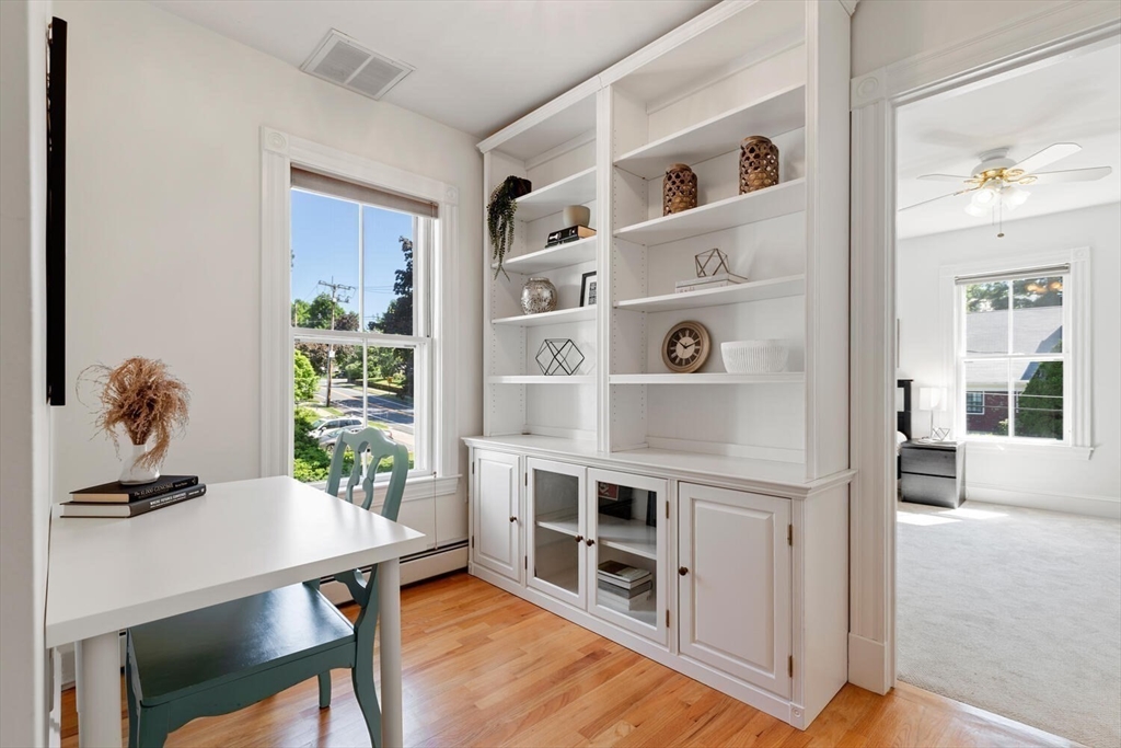 9 Bacon Street, Unit 9 Winchester, MA 01890 - Photo 18 of 35 a living room with hard wood floor and a table