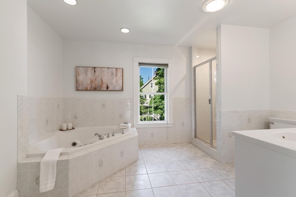 9 Bacon Street, Unit 9 Winchester, MA 01890 - Photo 21 of 35 a bathroom with a bathtub and a shower