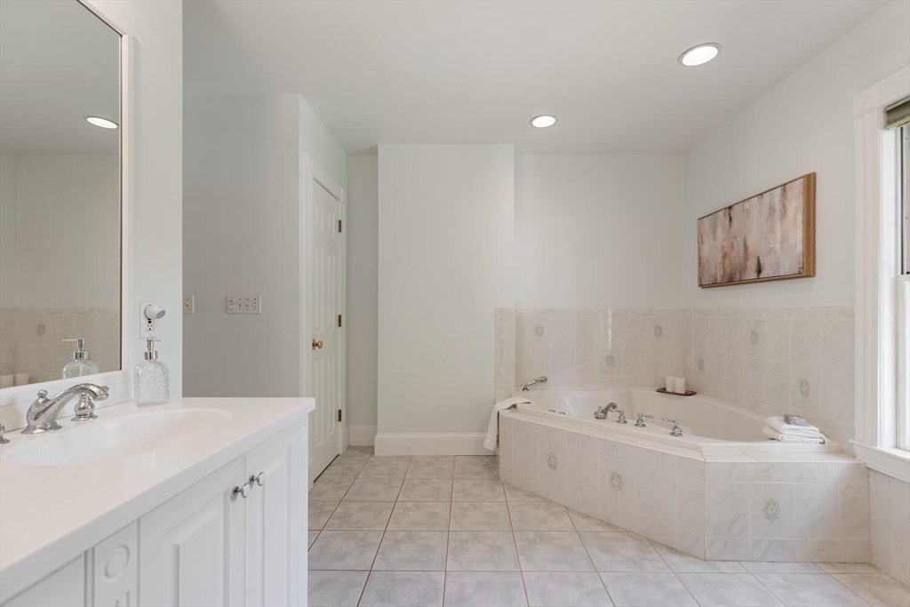9 Bacon Street, Unit 9 Winchester, MA 01890 - Photo 22 of 35 a bathroom with a bathtub and a sink