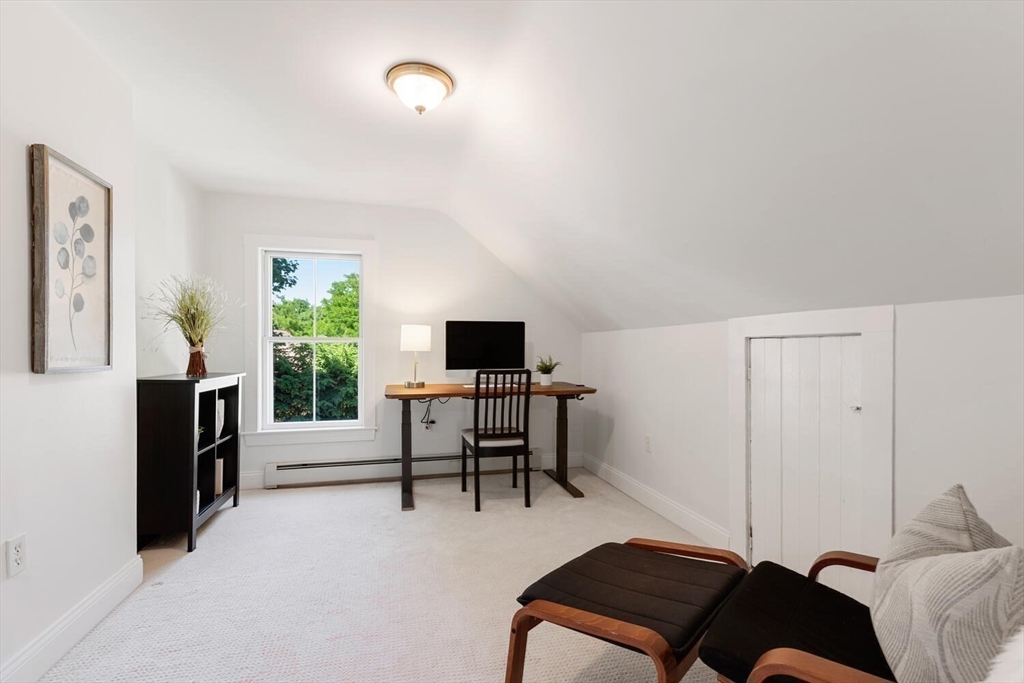 9 Bacon Street, Unit 9 Winchester, MA 01890 - Photo 24 of 35 a living room with furniture and a flat screen tv