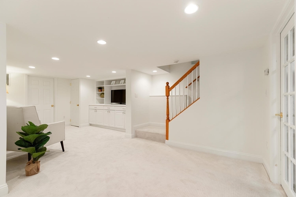 9 Bacon Street, Unit 9 Winchester, MA 01890 - Photo 26 of 35 a view of a livingroom with a staircase
