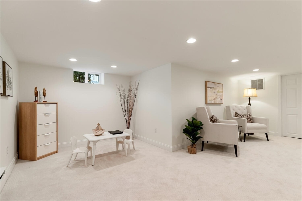 9 Bacon Street, Unit 9 Winchester, MA 01890 - Photo 27 of 35 a living room with furniture and a chair