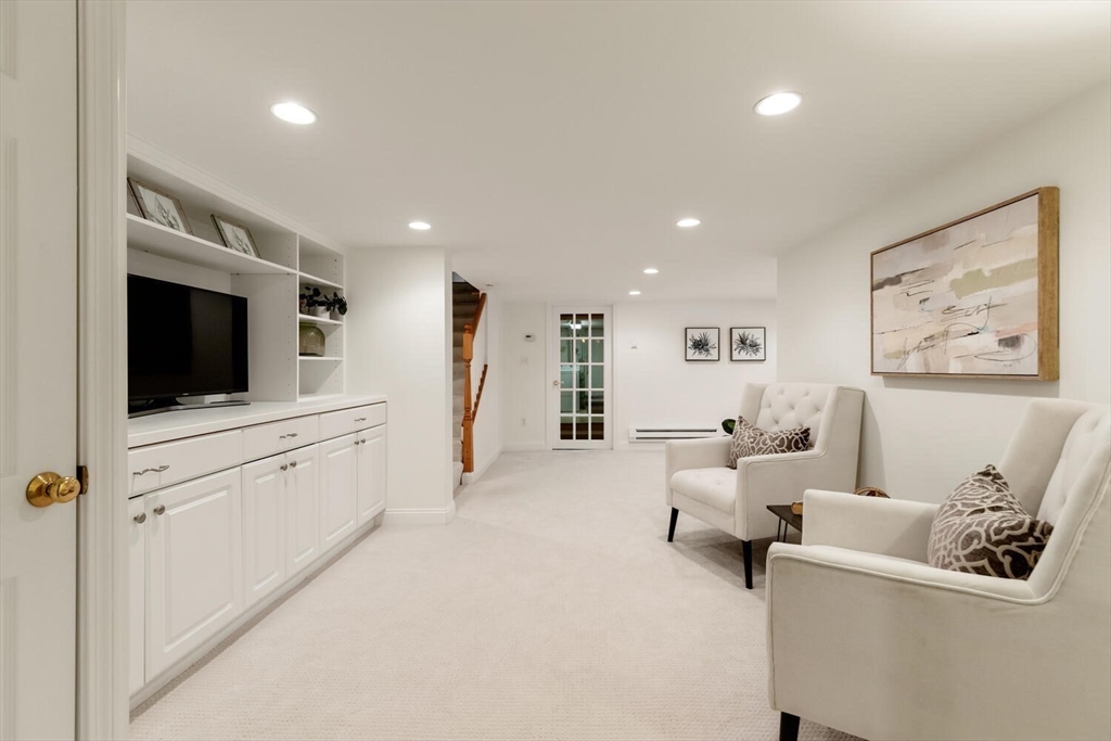 9 Bacon Street, Unit 9 Winchester, MA 01890 - Photo 28 of 35 a living room with furniture and a flat screen tv