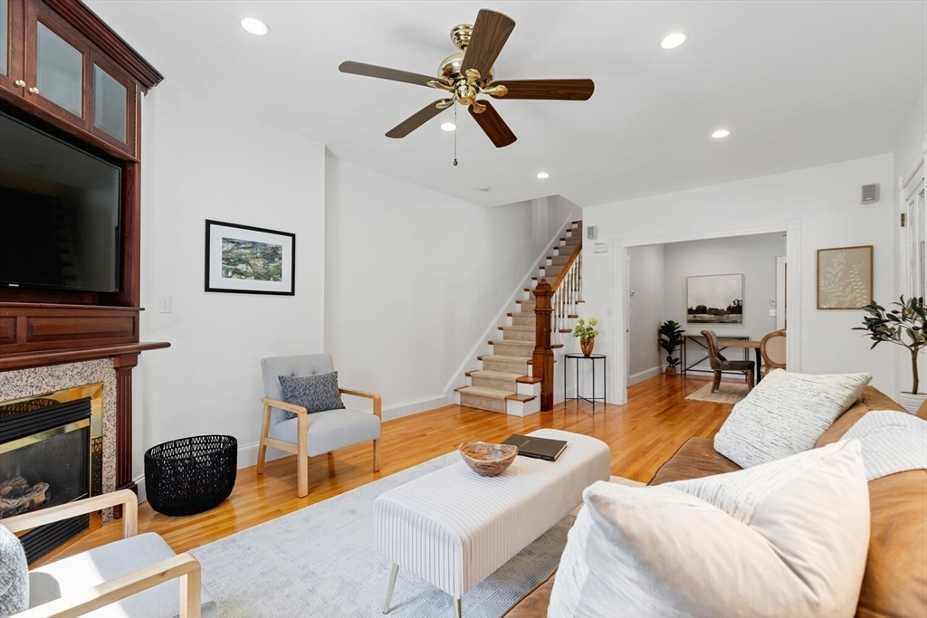 9 Bacon Street, Unit 9 Winchester, MA 01890 - Photo 7 of 35 a living room with furniture a flat screen tv and a fireplace