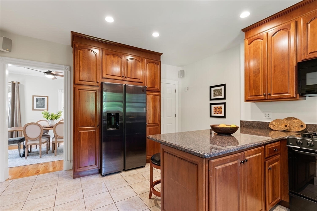 9 Bacon Street, Unit 9 Winchester, MA 01890 - Photo 10 of 35 a kitchen with granite countertop a refrigerator and a sink