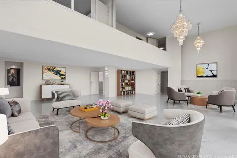 a living room with furniture and a chandelier