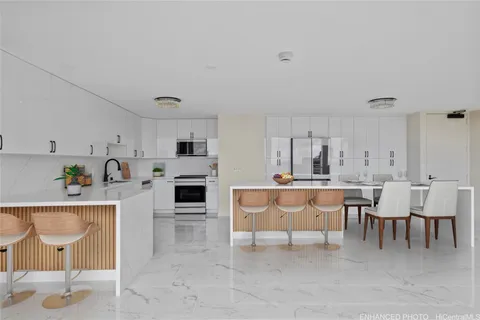 a living room with furniture a fireplace and kitchen view