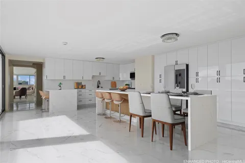 a view of kitchen with furniture and a refrigerator