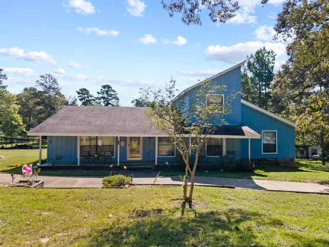a view of a house with swimming pool and a yard