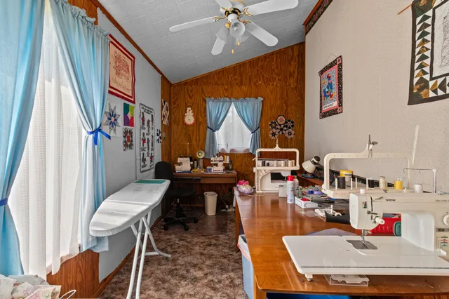 a workspace with furniture window and wooden floor