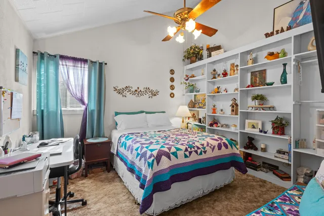 a bedroom with a bed furniture and a baby crib