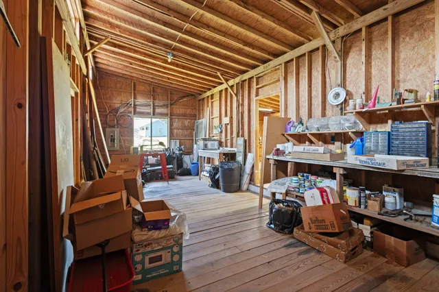 a room with wooden furniture and large windows