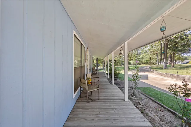 a view of a porch with wooden floor and outdoor space