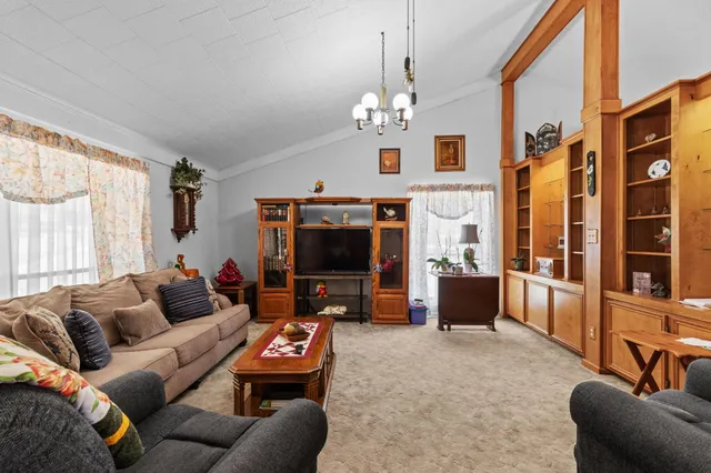 a living room with furniture a flat screen tv and a window